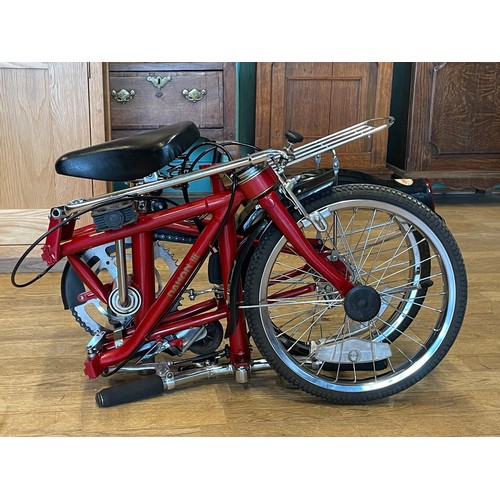 36 - A Dahon folding bicycle, metallic red with carry case.