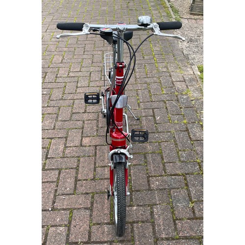 36 - A Dahon folding bicycle, metallic red with carry case.