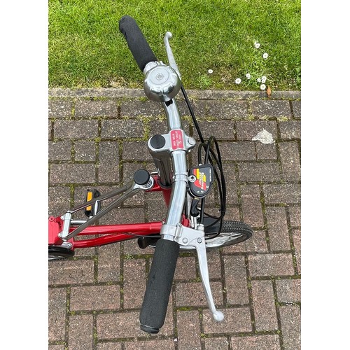 36 - A Dahon folding bicycle, metallic red with carry case.