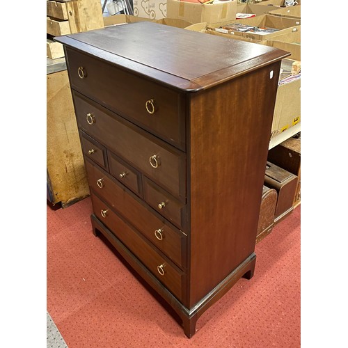 399 - A Stag Minstrel tallboy/chest of drawers, having three small central drawers with two deep drawers a... 