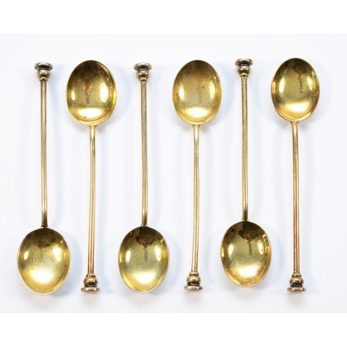 6 - A silver gilt and enamel set of six coffee spoons, Birmingham  1957, the bowls decorated with differ... 