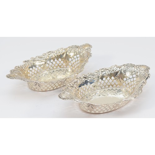 34 - A Victorian silver pair of bon bon dishes, by Nathan & Haynes, Chester 1899, of oval pierced form, 1... 