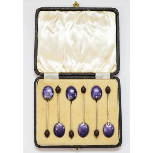 7 - An Art Deco set of silver and enamel bean end coffee spoons, Birmingham 1928, the bowls with purple ... 