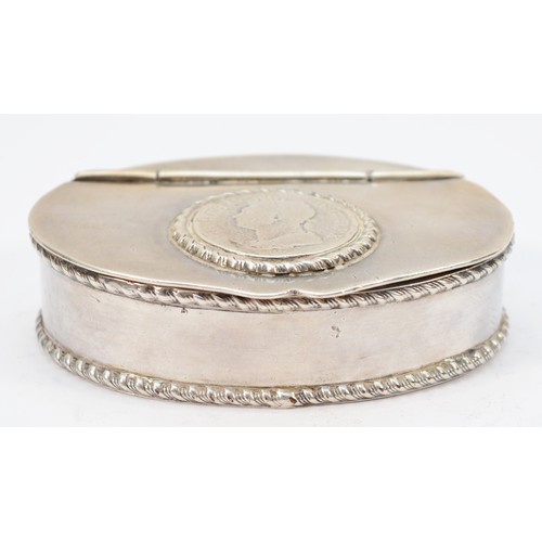 61 - An unmarked white metal oval snuff box, the hinged lid inset with a George IV coin, gadrooned border... 