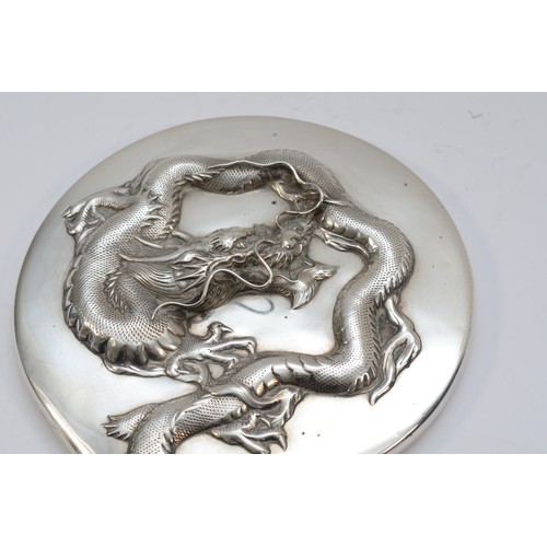 55 - A Chinese silver hand mirror, by Wing Nam & Co, Hong Kong, c.1900/10, with applied four claw dragon,... 