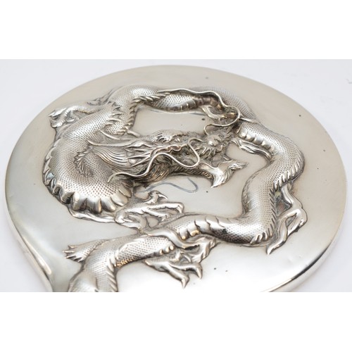 55 - A Chinese silver hand mirror, by Wing Nam & Co, Hong Kong, c.1900/10, with applied four claw dragon,... 