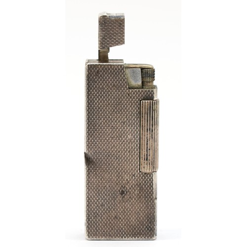 81 - Dunhill, an unusual silver petrol lighter, by Alfred Dunhill & Sons, Birmingham 1975, with engine tu... 