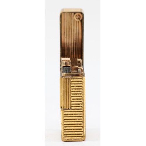 84 - S.T. Dupont, Paris, a gold plated gas lighter, N5156, with ribbed body, 4.6cm