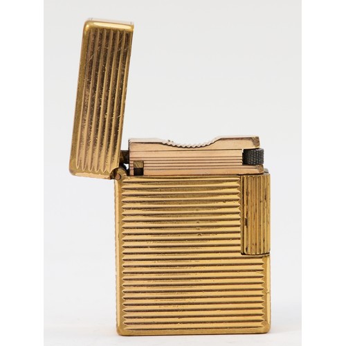 84 - S.T. Dupont, Paris, a gold plated gas lighter, N5156, with ribbed body, 4.6cm