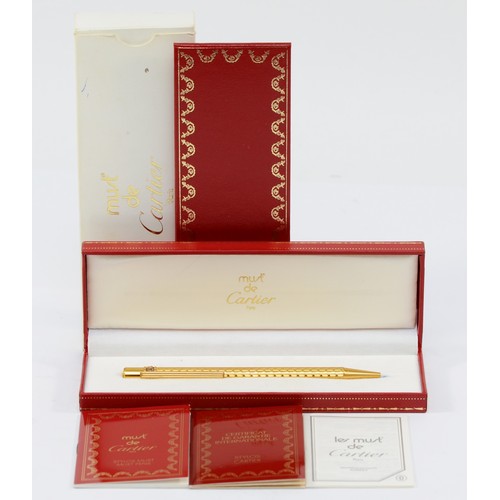 87 - Cartier, de Must, a gold plated Stylos ball point pen, c.1992, with booklets, case and box.
Very goo... 