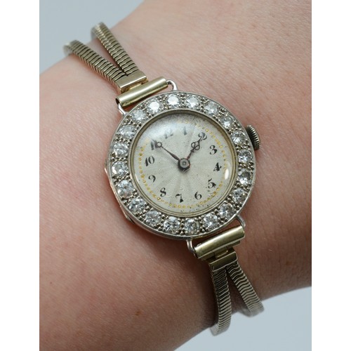 106 - A platinum and diamond maual wind ladies wristwatch, c.1930's, silvered dial with Arabic numerals, u... 