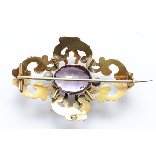 115 - A Victorian unmarked gold and amethyst brooch, with chased foliate scroll frame, 60 x 40mm, 12gm.