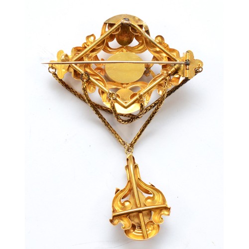 116 - A Victorian unmarked gold foiled pink gemstone drop brooch, with foliate scroll frame and swag chain... 