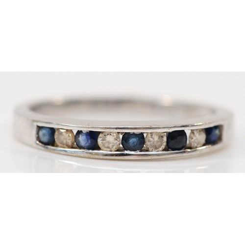 119 - A 9ct white gold sapphire and brilliant cut diamond set half eternity ring, stated weight 0.15cts, O... 