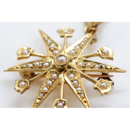 122 - A Victorian 15ct gold and half pearl eight ray star brooch/pendant, detachable bail, 29mm, 4.5gm