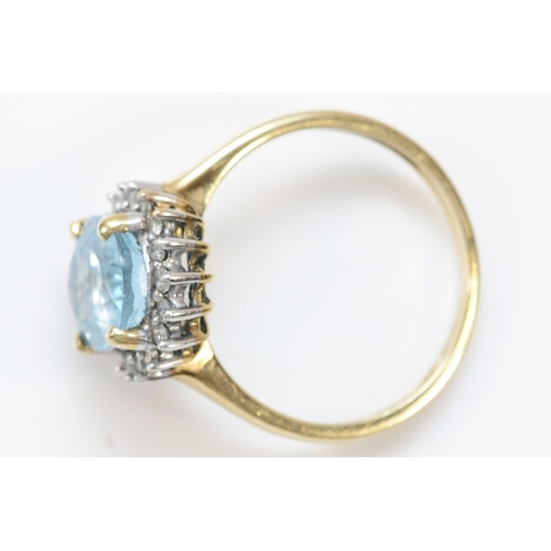 131 - A 9ct gold aquamarine and brilliant cut diamond cluster ring, stone 10 x 8mm, O, 3.2gm