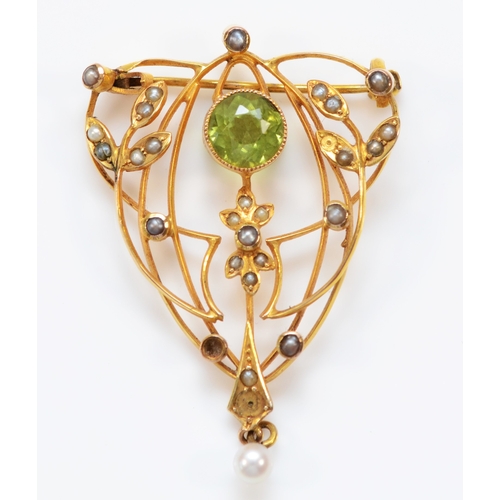 132 - An Edwardian 9ct gold, peridot and half pearl openwork brooch, 38 x 26mm, 3.4gm