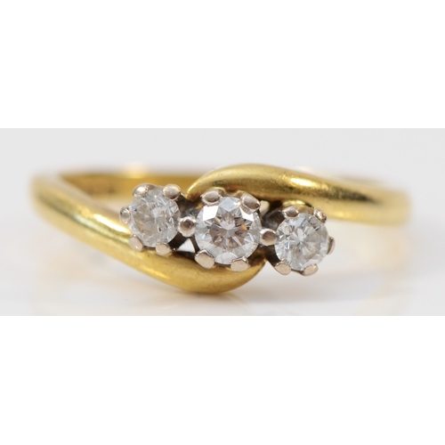 133 - An 18ct gold and brilliant cut diamond crossover three stone ring, stated weight 0.33cts, L, 3.5gm