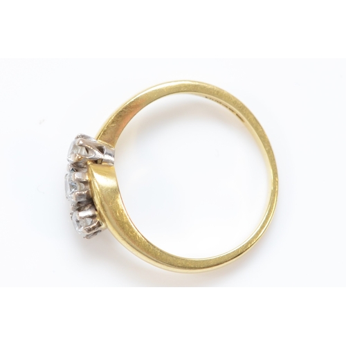 133 - An 18ct gold and brilliant cut diamond crossover three stone ring, stated weight 0.33cts, L, 3.5gm