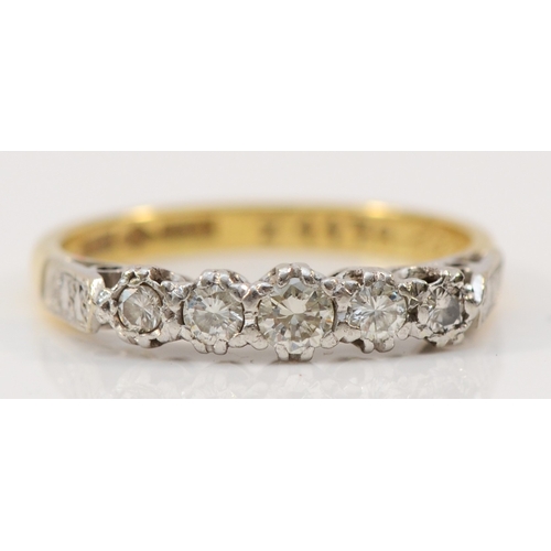 135 - An 18ct gold and platinum vintage five stone diamond ring, claw set with graduated brilliant cut sto... 