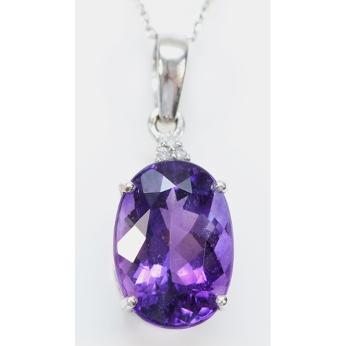 143 - A 9ct white gold amethyst pendant, claw set with a mixed cut stone of good colour, 14 x 10mm, brilli... 