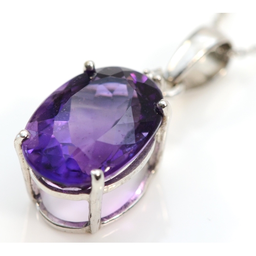 143 - A 9ct white gold amethyst pendant, claw set with a mixed cut stone of good colour, 14 x 10mm, brilli... 