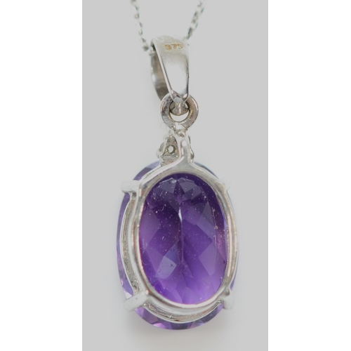 143 - A 9ct white gold amethyst pendant, claw set with a mixed cut stone of good colour, 14 x 10mm, brilli... 