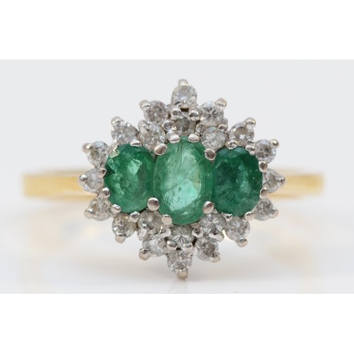 174 - A vintage 18ct gold emerald and diamond cluster ring, claw set with three graduated mixed cut stones... 