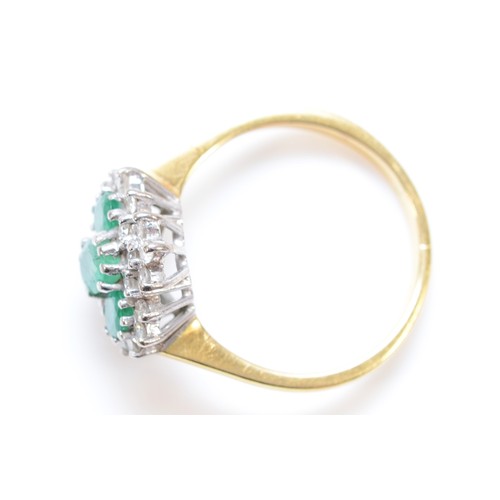 174 - A vintage 18ct gold emerald and diamond cluster ring, claw set with three graduated mixed cut stones... 