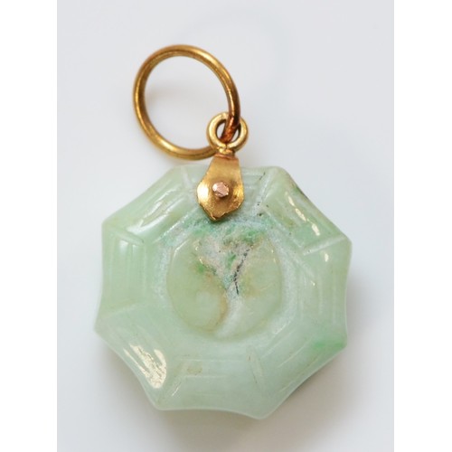 178 - A Chinese gold mounted jadeite Jin/Jan pendant, bordered by a spiders web, diameter 15mm