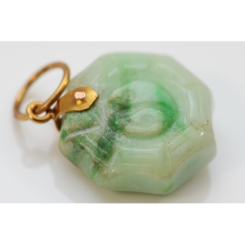 178 - A Chinese gold mounted jadeite Jin/Jan pendant, bordered by a spiders web, diameter 15mm