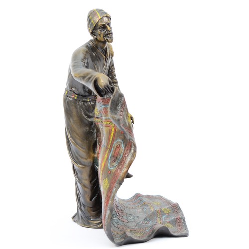 190 - A cold painted bronze model of an Arab carpet seller, signed 'Bergman' later casting, with foundry s... 