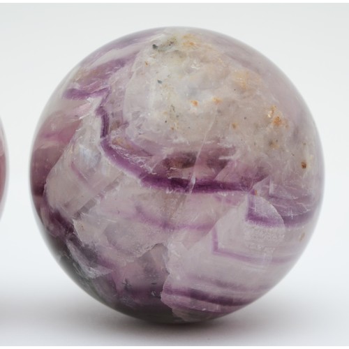 192 - A set of four Blue John balls, 62mm diameter