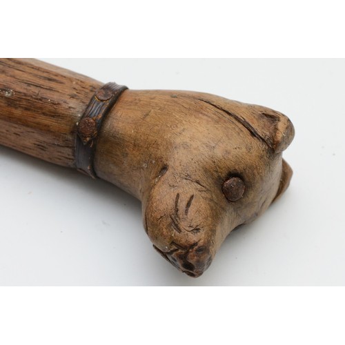 197 - A late 19th century carved fruitwood walking stick, the carved dogs head terminal with glass bead ey... 