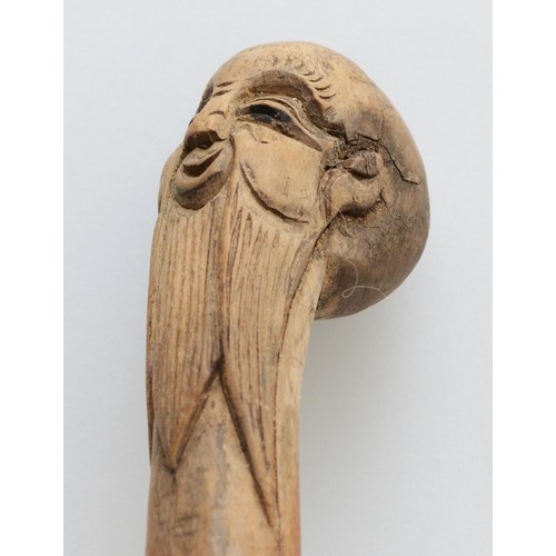 198 - An Oriental walking stick of tapering form, the handle carved with the head of a Chinese Immortal, 9... 