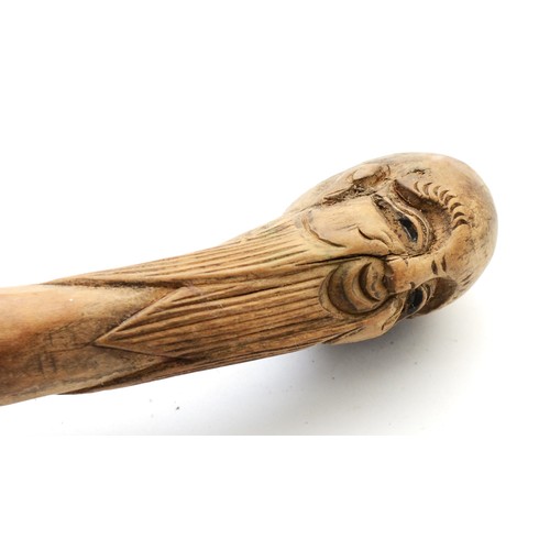 198 - An Oriental walking stick of tapering form, the handle carved with the head of a Chinese Immortal, 9... 