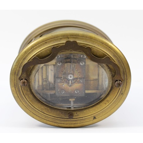 221 - An early 20th century brass case carriage clock, of oval form with painted dial and Roman numerals, ... 