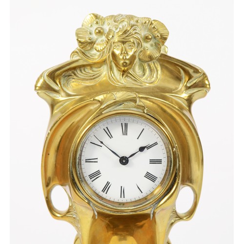 248 - An Art Nouveau gilt brass 8 day mantel clock, in the form of a cloaked female figure holding a clock... 