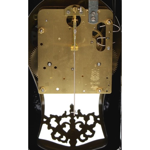 261 - A 20th century eight day mantel clock, the painted and ebonised case with simulated floral inlay and... 