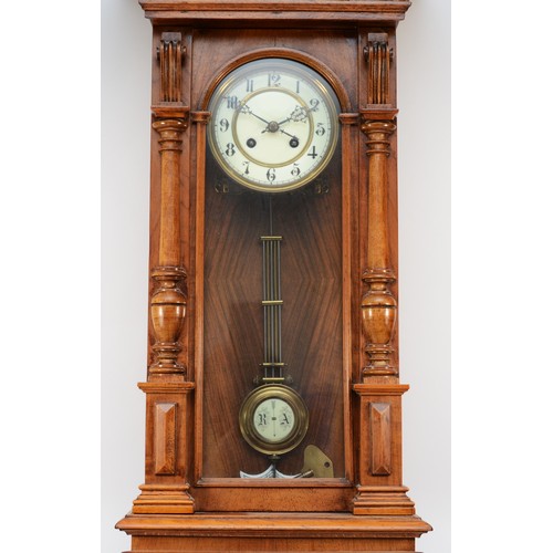 267 - A 20th century mahogany cased Vienna style wall clock, with a stepped pediment and finials, the two ... 