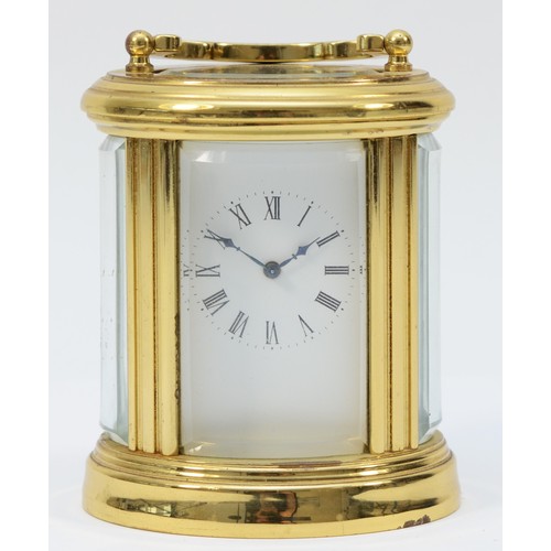 233 - A miniature brass case carriage clock, circa 20th century, of oval form having a French 8 day moveme... 