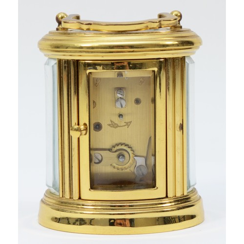 233 - A miniature brass case carriage clock, circa 20th century, of oval form having a French 8 day moveme... 