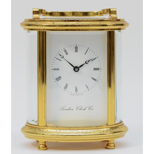 235 - A 20th century English oval brass case carriage clock, the white enamelled dial with Roman numerals,... 