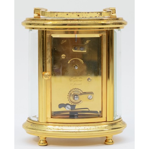 235 - A 20th century English oval brass case carriage clock, the white enamelled dial with Roman numerals,... 