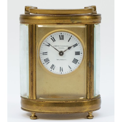 236 - An early 20th century gilt brass carriage clock, of oval form with swing handle on bun feet, having ... 