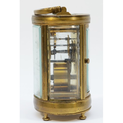 236 - An early 20th century gilt brass carriage clock, of oval form with swing handle on bun feet, having ... 