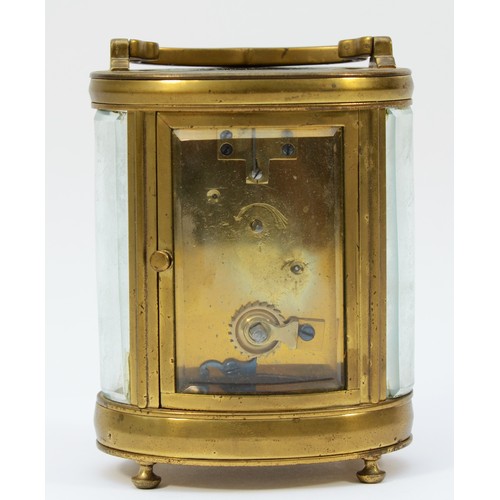 236 - An early 20th century gilt brass carriage clock, of oval form with swing handle on bun feet, having ... 