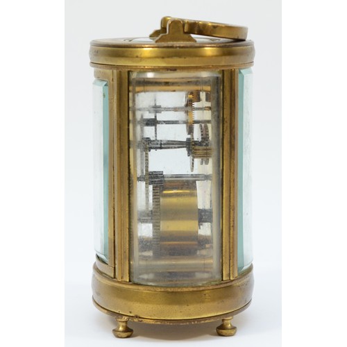 236 - An early 20th century gilt brass carriage clock, of oval form with swing handle on bun feet, having ... 