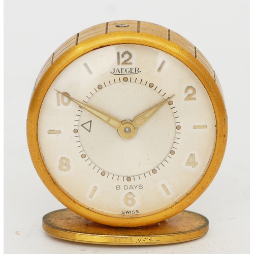 250 - Jaeger, a gilt metal 8  day travel alarm clock, model 51, mounted on a stand, with original 1956 rec... 