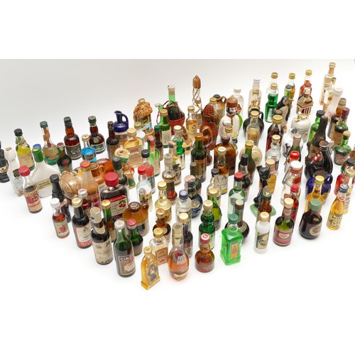 302 - A large quantity of alcohol miniatures to include Gilbeys gin, Pickwick Scotch whisky, Leg Bender- C... 